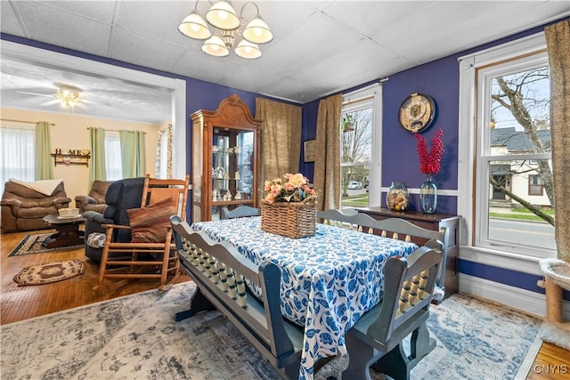 601 W Thomas St, Rome-Inside, NY 13440 - dining area with baseboards, wood finished floors, a chandelier, and a drop ceiling