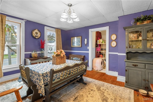 601 W Thomas St, Rome-Inside, NY 13440 - dining room with baseboards, wood finished floors, a notable chandelier, and a drop ceiling