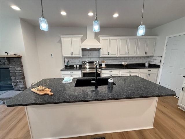 2002 Maes Lndg, Canandaigua-Town, NY 14424 - kitchen with tasteful backsplash, electric stove, light wood-style flooring, premium range hood, and white cabinetry