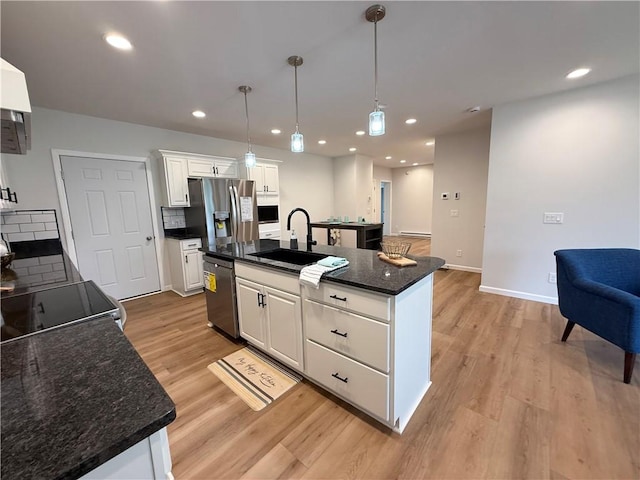 2002 Maes Lndg, Canandaigua-Town, NY 14424 - kitchen featuring light wood-style flooring, a sink, white cabinetry, appliances with stainless steel finishes, and hanging light fixtures
