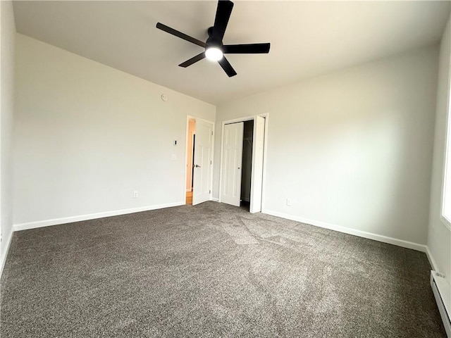 2002 Maes Lndg, Canandaigua-Town, NY 14424 - spare room featuring a baseboard heating unit, dark colored carpet, baseboards, and ceiling fan