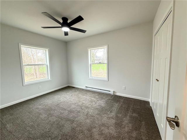 2002 Maes Lndg, Canandaigua-Town, NY 14424 - unfurnished bedroom with baseboards, dark carpet, a closet, ceiling fan, and a baseboard radiator