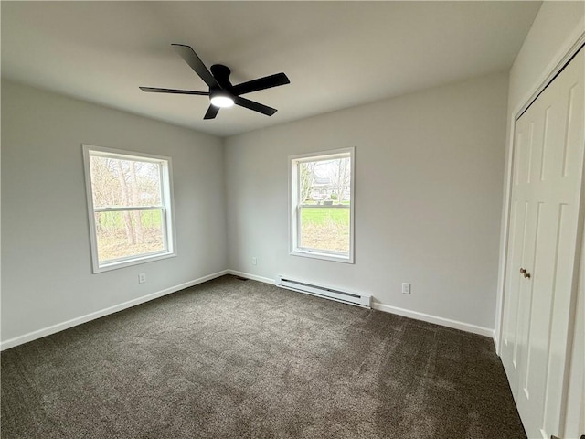 2002 Maes Lndg, Canandaigua-Town, NY 14424 - unfurnished bedroom featuring a baseboard heating unit, dark colored carpet, a closet, and multiple windows
