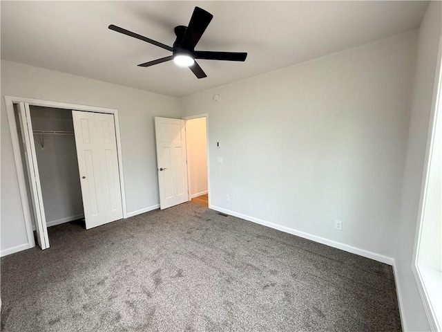 2002 Maes Lndg, Canandaigua-Town, NY 14424 - unfurnished bedroom with dark carpet, baseboards, a ceiling fan, and a closet