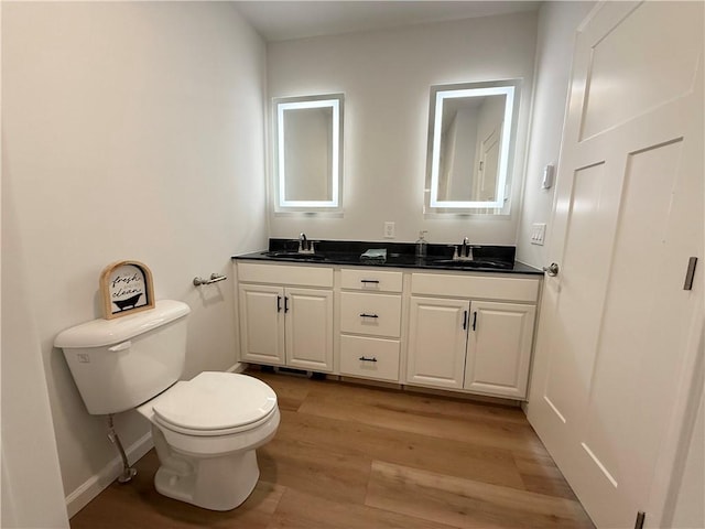2002 Maes Lndg, Canandaigua-Town, NY 14424 - bathroom featuring double vanity, wood finished floors, toilet, and a sink