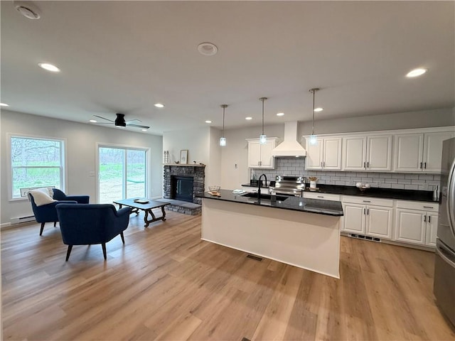 2002 Maes Lndg, Canandaigua-Town, NY 14424 - kitchen featuring stainless steel appliances, custom exhaust hood, a fireplace, and dark countertops