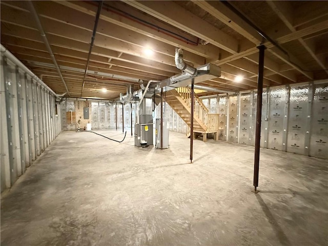 2002 Maes Lndg, Canandaigua-Town, NY 14424 - unfinished basement with electric panel, heating unit, stairs, and gas water heater