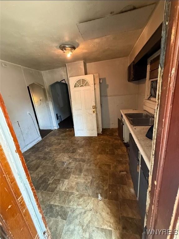 2219 Walnut Ave, Niagara Falls, NY 14301 - kitchen featuring dark stone finish floors, a sink, and light countertops
