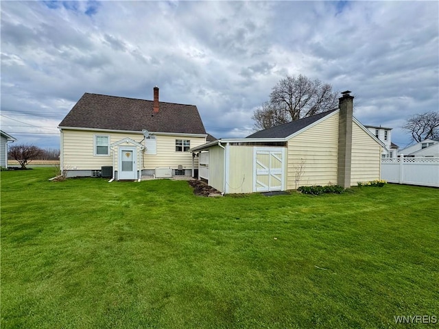 1432 Quaker Rd, Somerset, NY 14012 - back of property with a lawn, an outbuilding, a chimney, and cooling unit