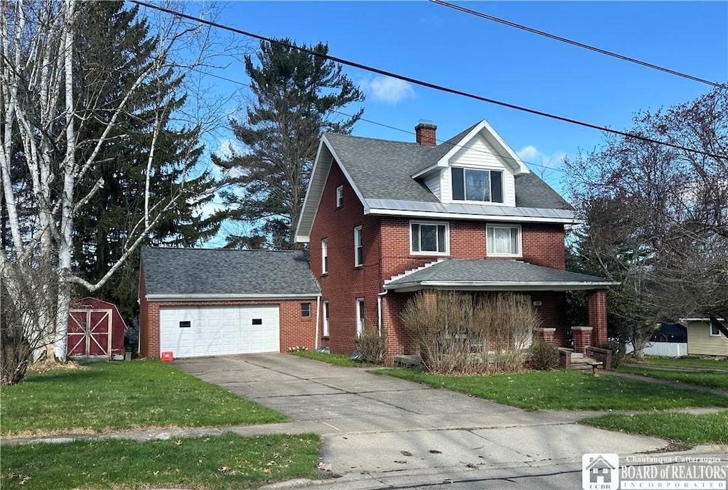 129 Willow Ave, Jamestown, NY 14701 - view of front of home with brick siding, a storage shed, a front yard, and concrete driveway