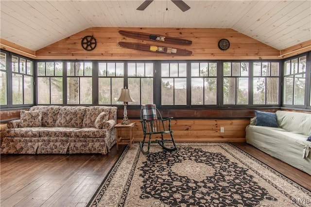 living area featuring wooden walls, vaulted ceiling, hardwood / wood-style floors, and wooden ceiling