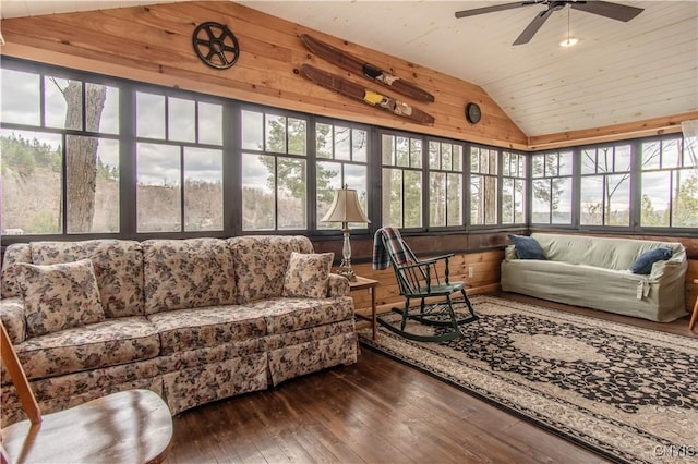 sunroom featuring lofted ceiling, hardwood / wood-style flooring, wood ceiling, and a healthy amount of sunlight