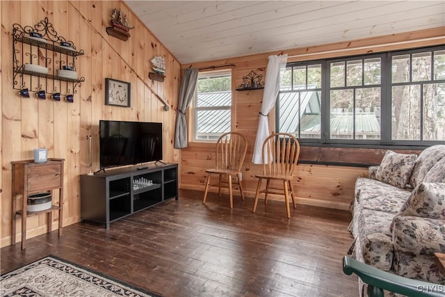 living room with lofted ceiling, hardwood / wood-style flooring, and wooden walls