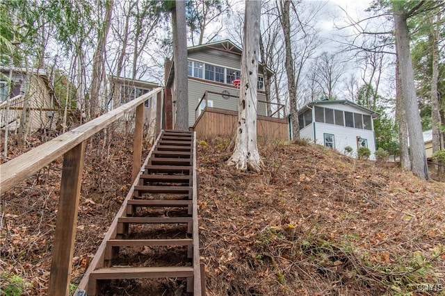 exterior space with a sunroom and stairway