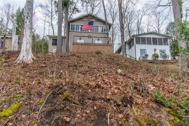 back of property with a sunroom