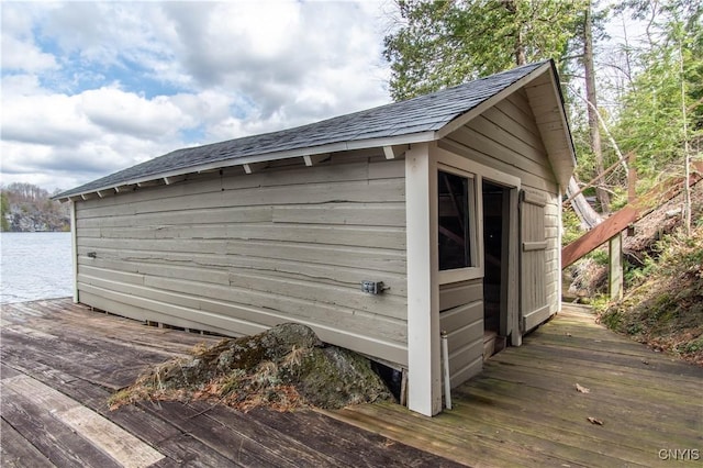 view of outdoor structure featuring an outbuilding and a water view