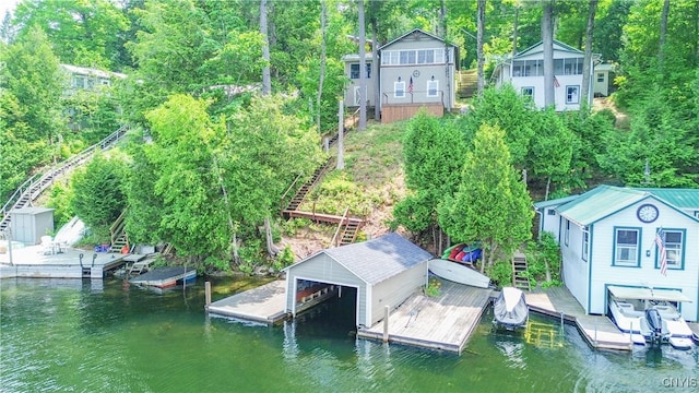 14204 S Bonaparte Rd, Diana, NY 13648 - dock featuring boat lift, stairs, and view of scattered trees