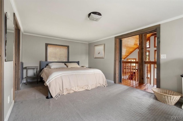carpeted bedroom with baseboards and ornamental molding