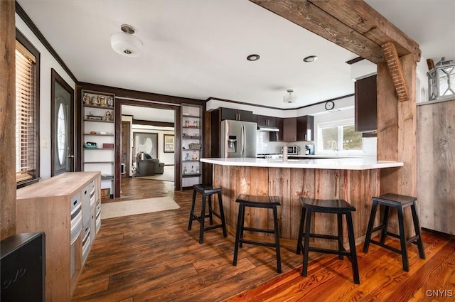 kitchen featuring light countertops, dark wood-style floors, and stainless steel fridge with ice dispenser