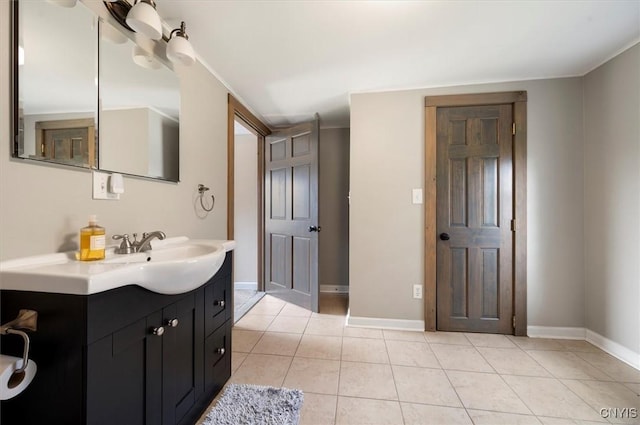 bathroom featuring vanity, tile patterned floors, and baseboards