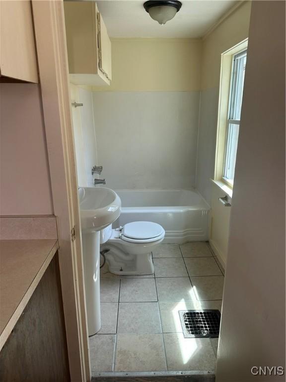 bathroom featuring toilet, a tub, tile patterned floors, and visible vents
