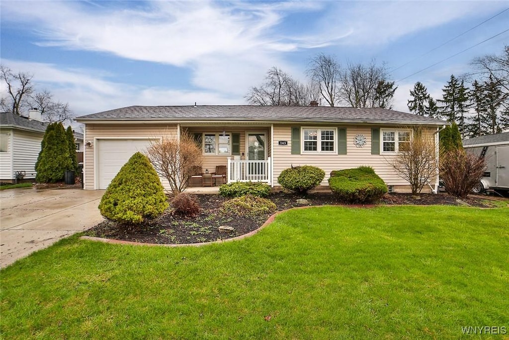 ranch-style house featuring concrete driveway, covered porch, a front yard, and a garage