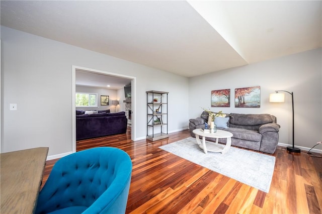 living room with baseboards and wood finished floors