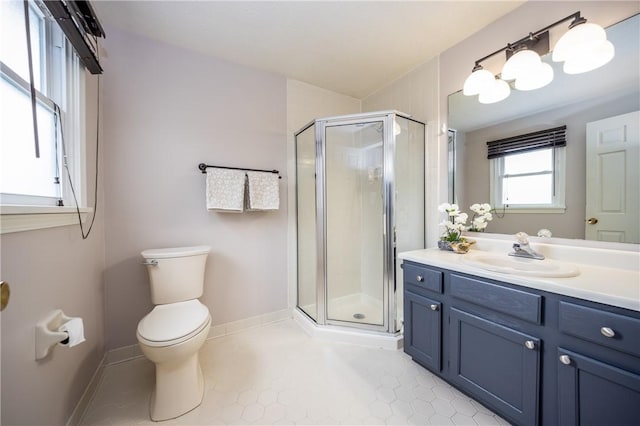 full bathroom with toilet, baseboards, vanity, and a stall shower
