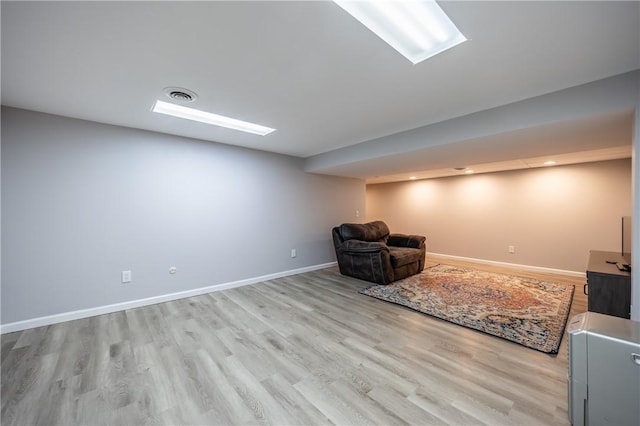 sitting room featuring light wood finished floors, baseboards, and visible vents