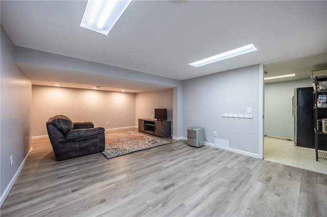 unfurnished living room with wood finished floors and baseboards