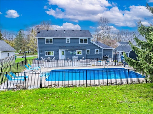view of pool featuring fence, a patio, a yard, and a fenced in pool