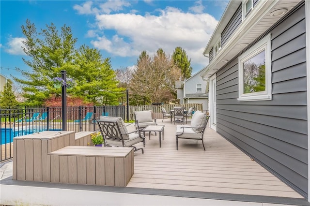 deck featuring fence, a fenced in pool, and outdoor dining space