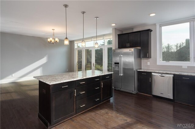 35 Ojibwa Cir, Buffalo, NY 14202 - kitchen with tasteful backsplash, an inviting chandelier, decorative light fixtures, dark wood finished floors, and appliances with stainless steel finishes