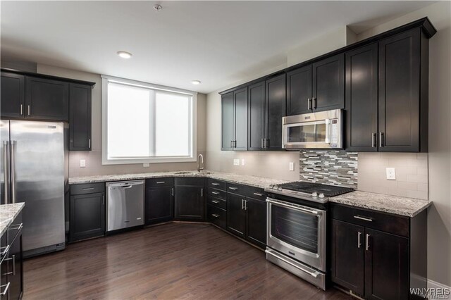 35 Ojibwa Cir, Buffalo, NY 14202 - kitchen with dark wood finished floors, light stone countertops, appliances with stainless steel finishes, and a sink