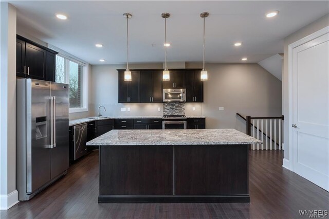 35 Ojibwa Cir, Buffalo, NY 14202 - kitchen featuring backsplash, a sink, a kitchen island, appliances with stainless steel finishes, and dark wood-style flooring