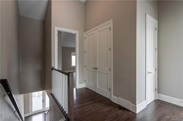 35 Ojibwa Cir, Buffalo, NY 14202 - hallway featuring dark wood finished floors, visible vents, baseboards, and an upstairs landing