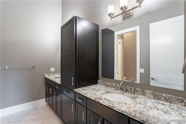 35 Ojibwa Cir, Buffalo, NY 14202 - bathroom featuring baseboards, marble finish floor, vanity, and toilet