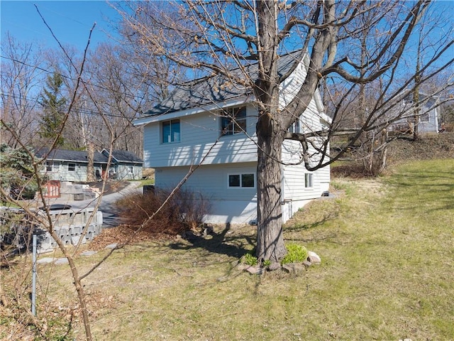 view of property exterior with a yard