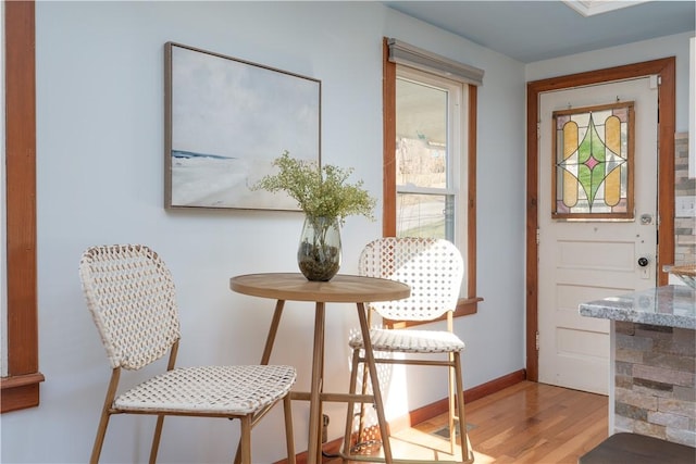 dining room with baseboards and wood finished floors