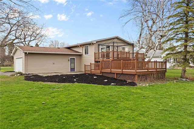 back of property with an attached garage, a lawn, and a deck