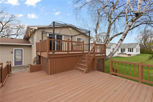 wooden terrace with a gazebo, a lawn, and stairs