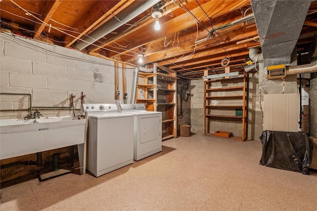 unfinished below grade area featuring washer and dryer and a sink