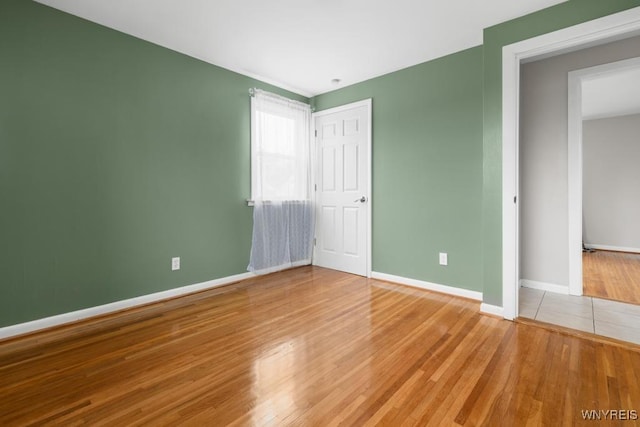 unfurnished bedroom featuring baseboards and wood finished floors