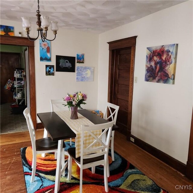 417 Otsego St, German Flatts, NY 13357 - dining area with baseboards, wood finished floors, and a chandelier