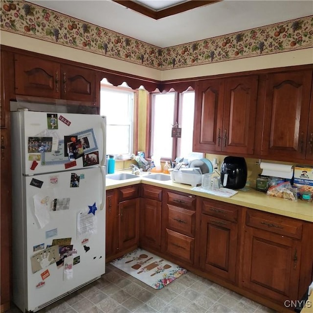 417 Otsego St, German Flatts, NY 13357 - kitchen with brown cabinets, light countertops, and freestanding refrigerator