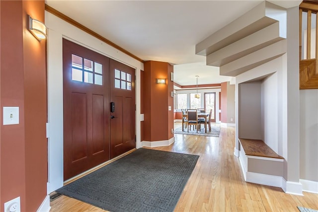 4872 Bedford Dr, Canandaigua-Town, NY 14424 - entryway with light wood-type flooring, baseboards, and ornamental molding