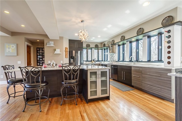 4872 Bedford Dr, Canandaigua-Town, NY 14424 - kitchen with light wood finished floors, stainless steel refrigerator with ice dispenser, a sink, and a kitchen bar
