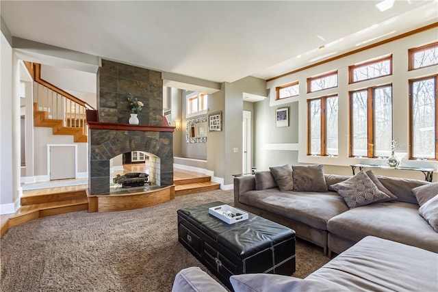 4872 Bedford Dr, Canandaigua-Town, NY 14424 - carpeted living area with stairway, baseboards, and a stone fireplace