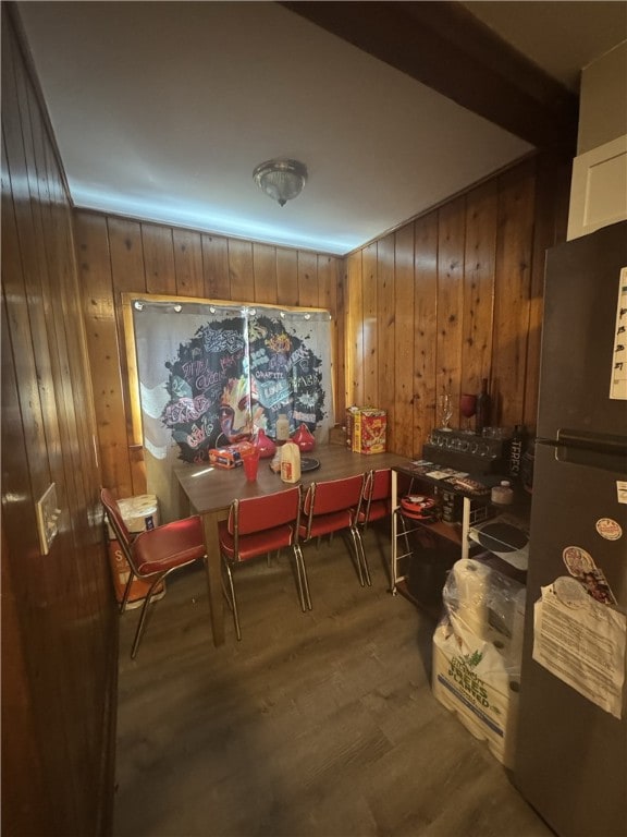 dining space with wood walls and wood finished floors