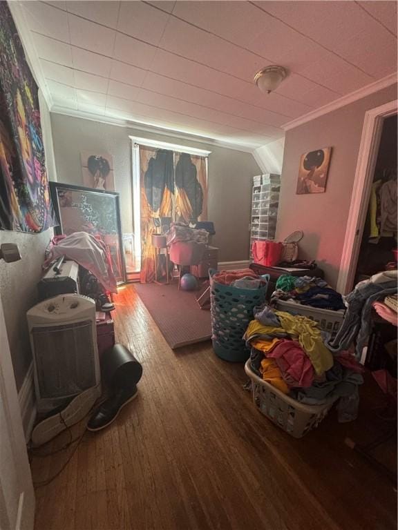 interior space featuring wood finished floors and crown molding